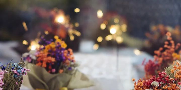 Flowers and candles on a table in warm evening light