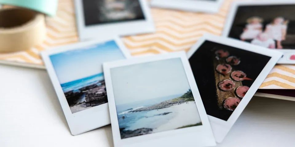 Printed instant photos spread on a table